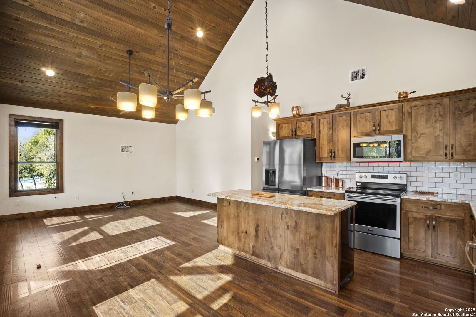 3615 Riverside Drive Kerrville, TX 78028 - Photo 13 of 50 a kitchen with stainless steel appliances granite countertop a stove a sink and a refrigerator