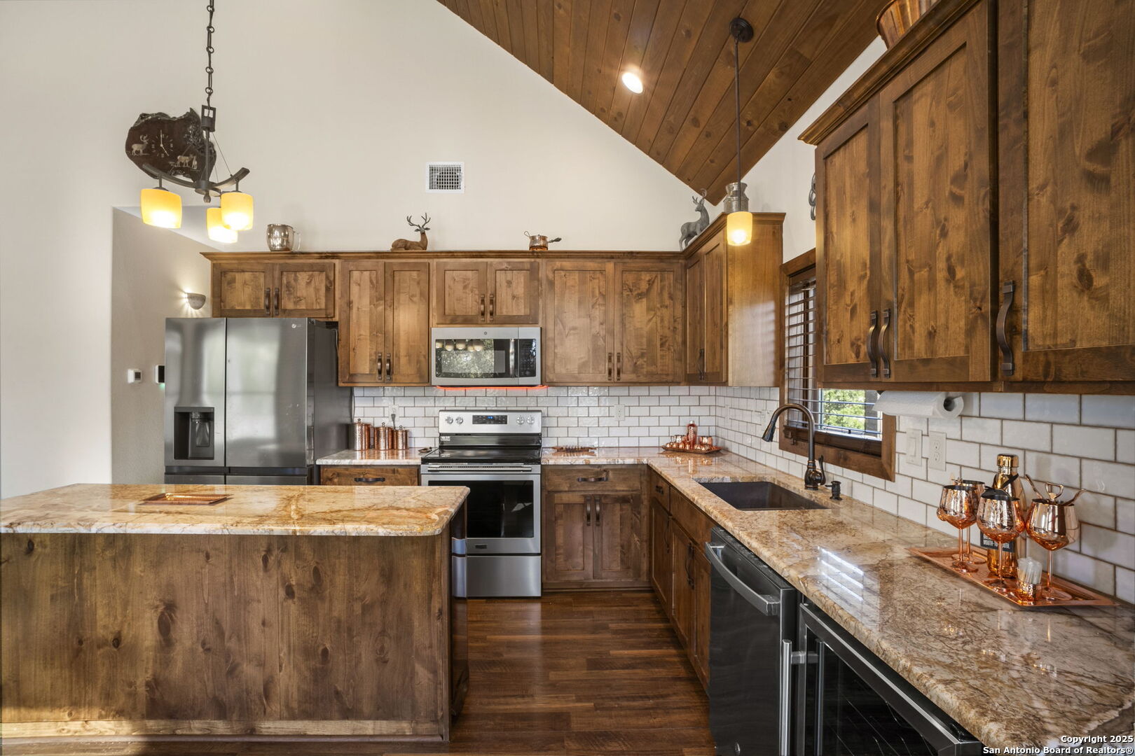 3615 Riverside Drive Kerrville, TX 78028 - Photo 14 of 50 a kitchen with stainless steel appliances granite countertop a stove a sink and a microwave