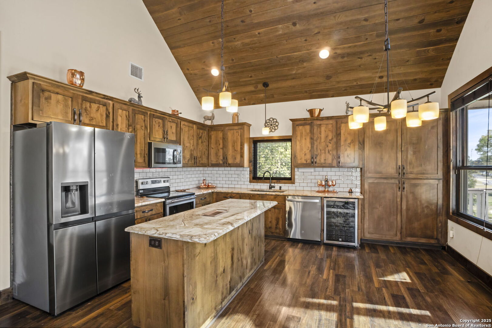 3615 Riverside Drive Kerrville, TX 78028 - Photo 17 of 50 a kitchen with refrigerator a stove a sink and dishwasher with wooden floor