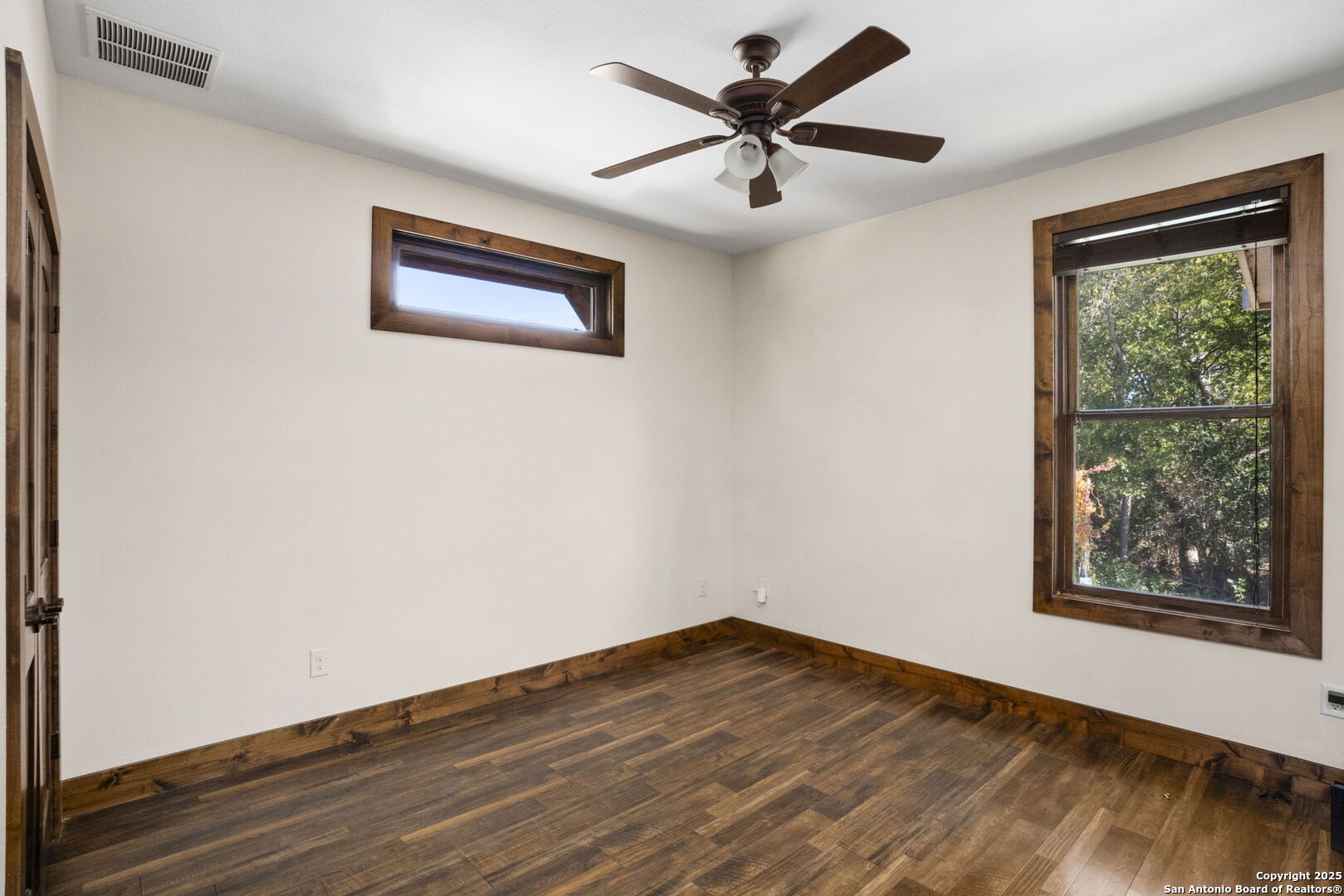 3615 Riverside Drive Kerrville, TX 78028 - Photo 23 of 50 a view of a big room with wooden floor and windows