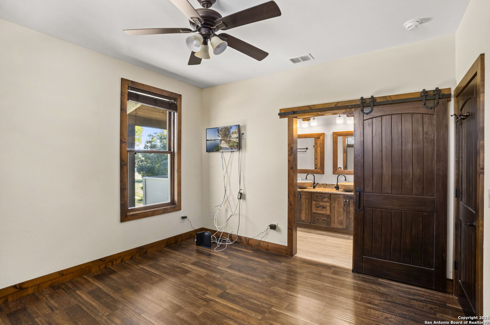 3615 Riverside Drive Kerrville, TX 78028 - Photo 31 of 50 a view of empty room with wooden floor and fan