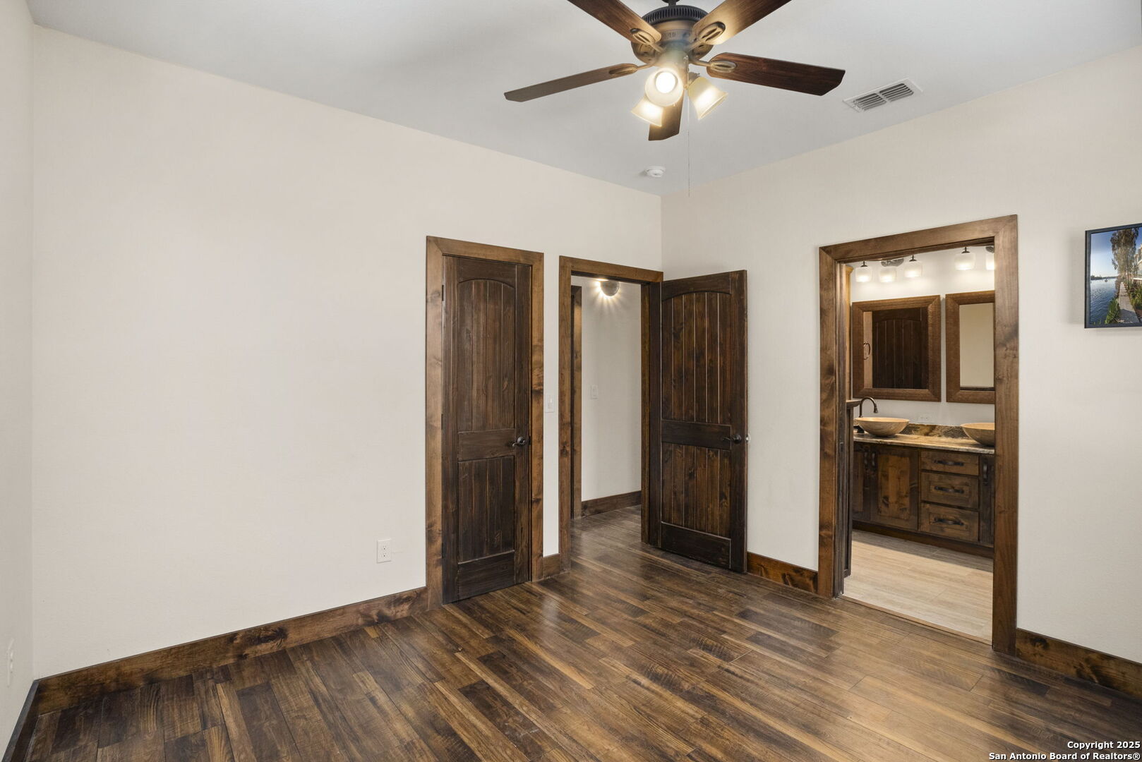 3615 Riverside Drive Kerrville, TX 78028 - Photo 33 of 50 an empty room with wooden floor closet and windows