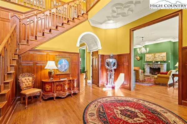 a living room with fireplace furniture and a chandelier
