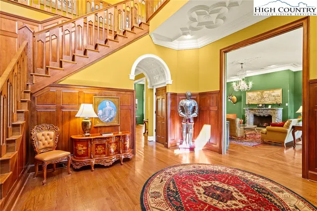 a living room with fireplace furniture and a chandelier