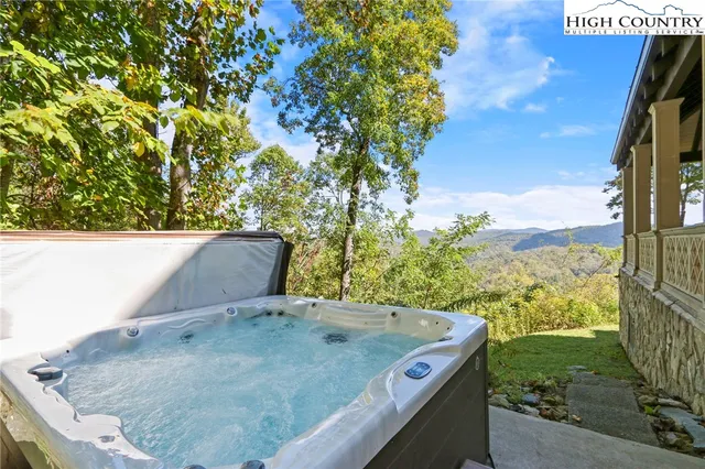 a dining room with furniture a rug and a chandelier
