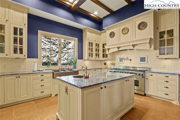 a kitchen with stainless steel appliances granite countertop a stove and a sink