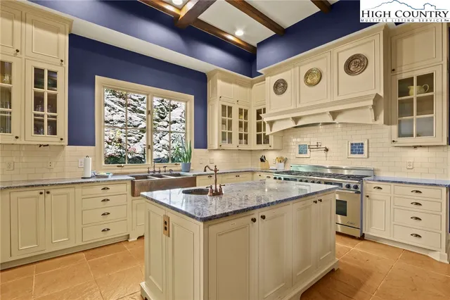 a kitchen with stainless steel appliances granite countertop a stove and a sink