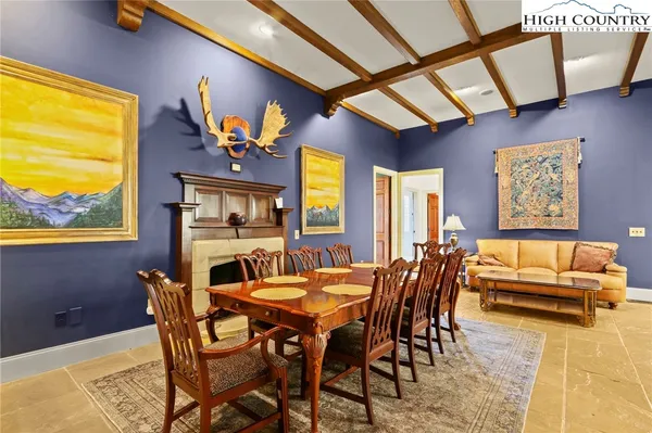 a view of a dining room with furniture and chandelier