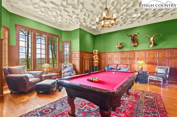 a dining room with furniture and wooden floor