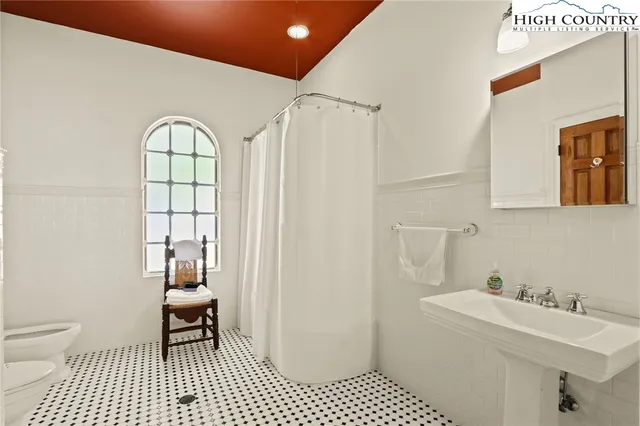 a bedroom with a bed couch and window