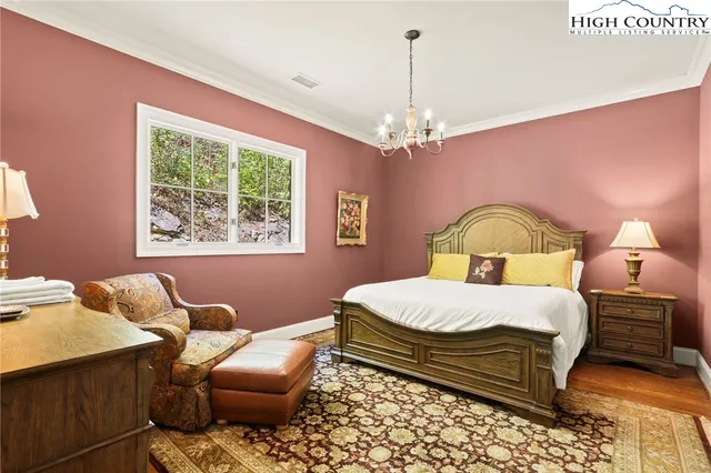 a bedroom with furniture and a wooden floor