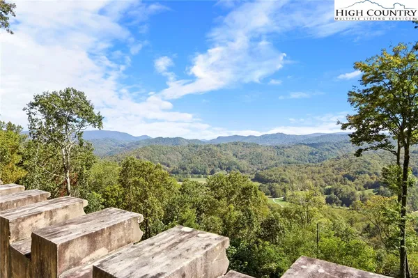 an aerial view of a house with swimming pool next to a yard