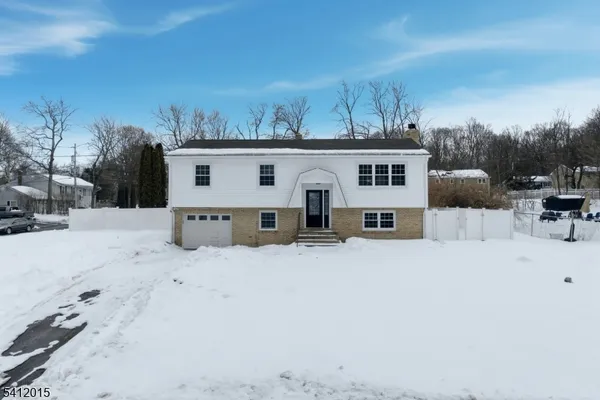 a view of a house with a snow in the background