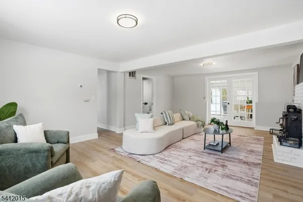 a living room with furniture and wooden floor