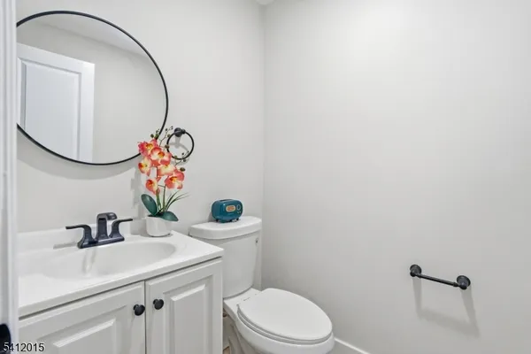 a bathroom with a sink mirror and toilet