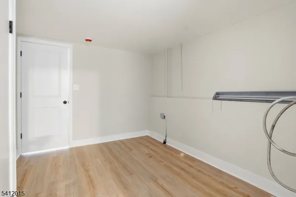 a view of a room with wooden floor and white walls