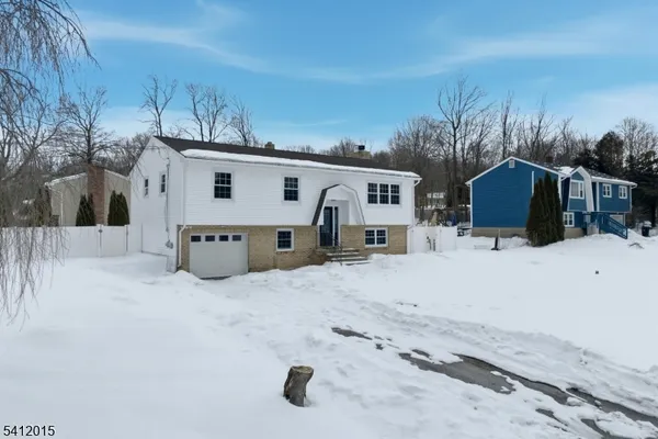 a view of a house with a snow in the yard