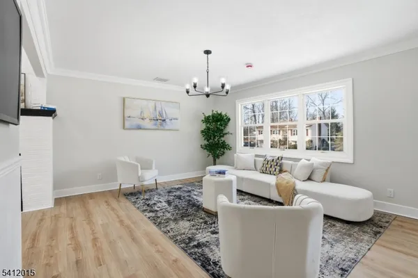 a living room with furniture and a chandelier