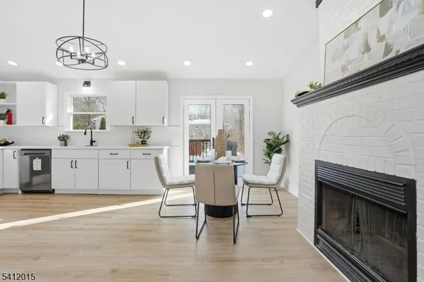 a living room with stainless steel appliances kitchen island granite countertop furniture and a fireplace