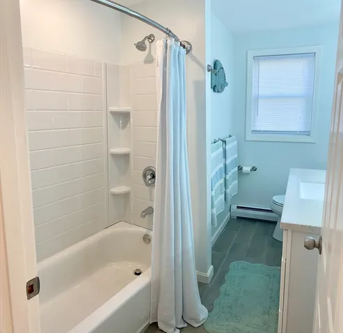 a bathroom with a bathtub and a shower