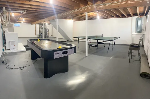 a room with pool table and chairs