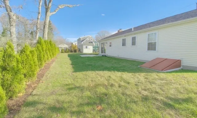 a view of a backyard of the house