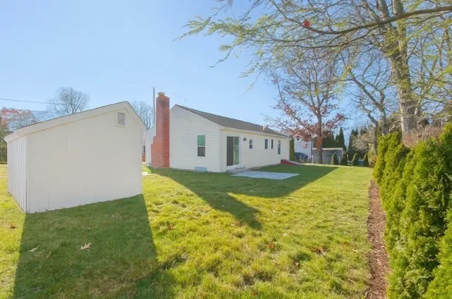 a view of house with backyard
