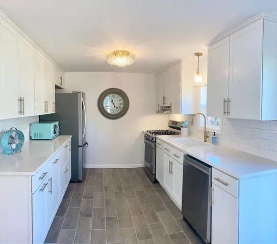a kitchen with a sink cabinets and a refrigerator