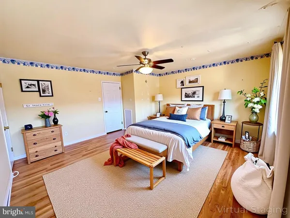 a bedroom with furniture and a wooden floor