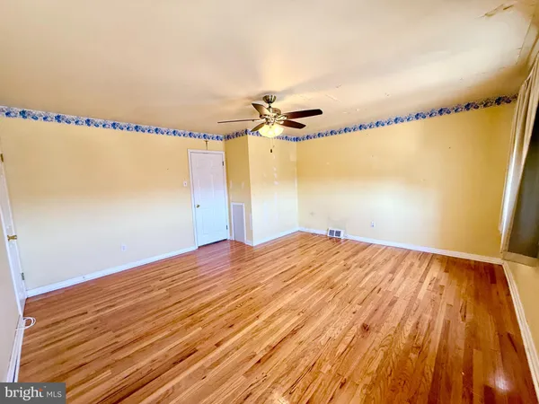a view of a room with wooden floor and wooden floors