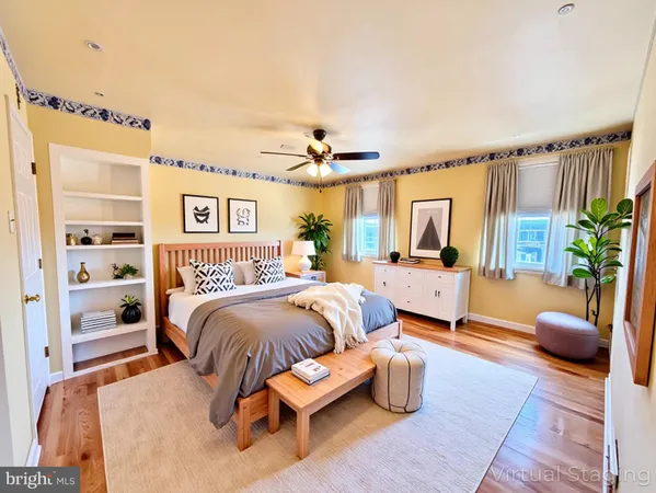 a bedroom with furniture and a large window