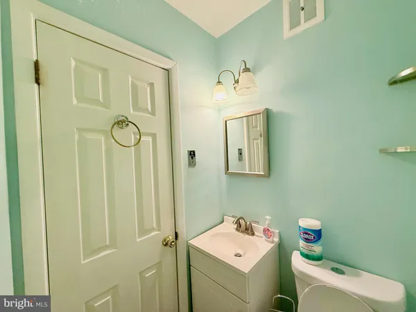 a bathroom with a sink toilet and vanity