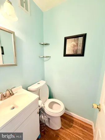 a white toilet sitting next to a bathroom sink