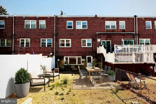 a view of a building with a bench in patio