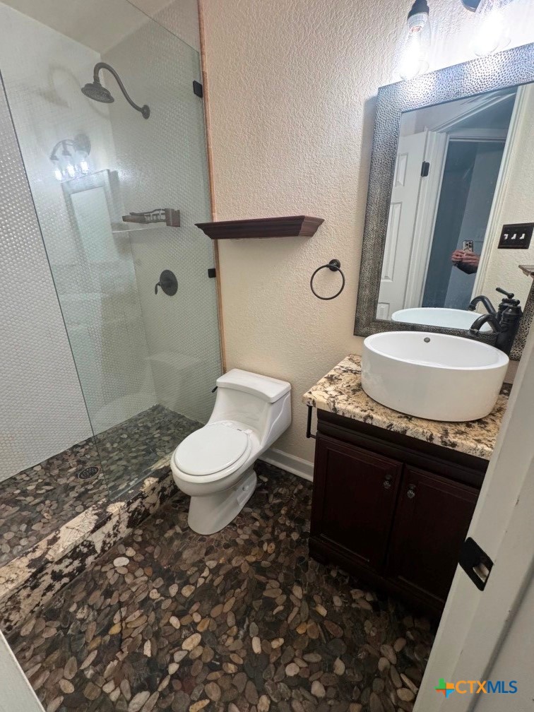 5524 Denmans Mountain Road Belton, TX 76513 - Photo 11 of 15 a bathroom with a granite countertop toilet sink and mirror