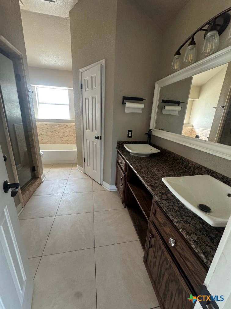 5524 Denmans Mountain Road Belton, TX 76513 - Photo 9 of 15 a kitchen with stainless steel appliances granite countertop a stove and a sink