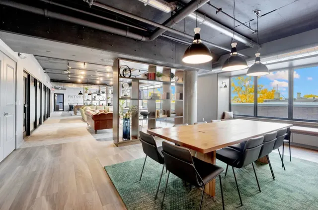 a room with wooden floor and windows