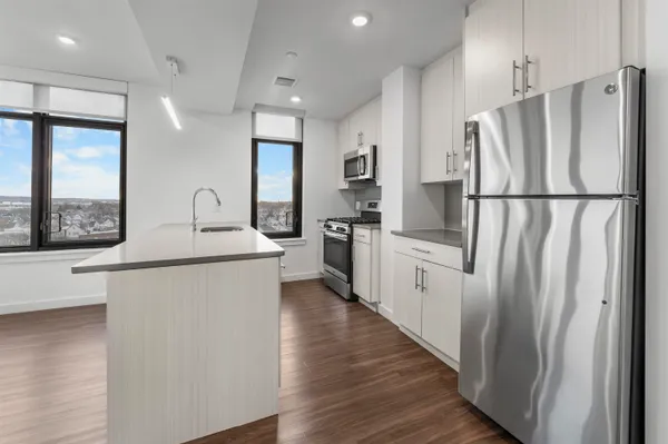 a kitchen with white cabinets and white stainless steel appliances