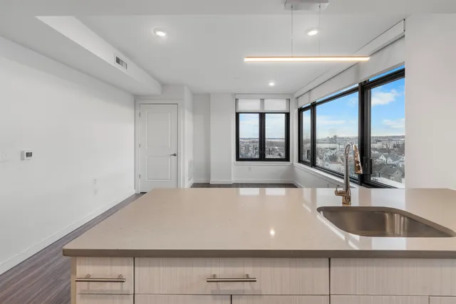 a view of a kitchen with a large window