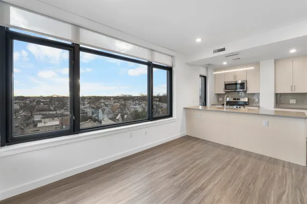 a view of a kitchen with large windows