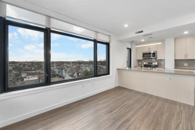 a view of a kitchen with large windows