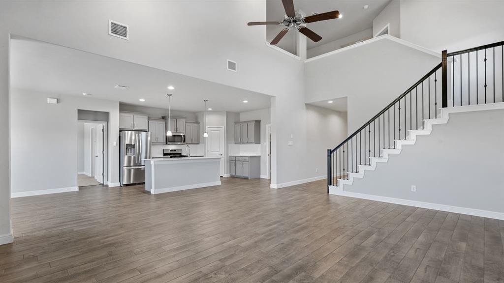 1909 Cookes Lane Cleburne, TX 76033 - Photo 9 of 40 a view of kitchen and kitchen with furniture a ceiling fan and wooden floor