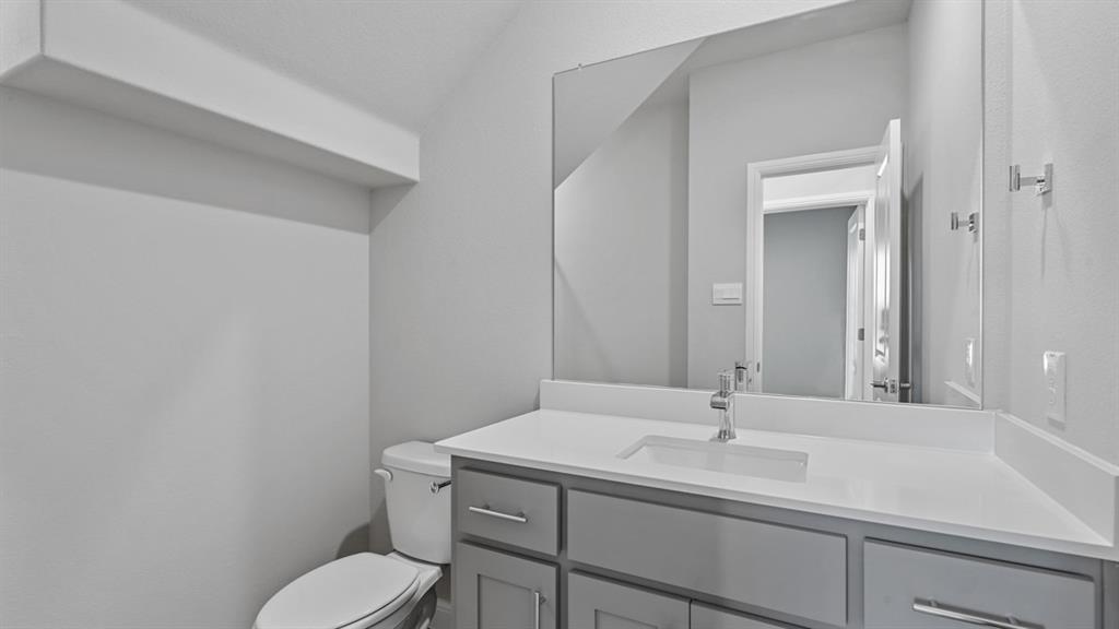 1909 Cookes Lane Cleburne, TX 76033 - Photo 22 of 40 a bathroom with a toilet sink and mirror