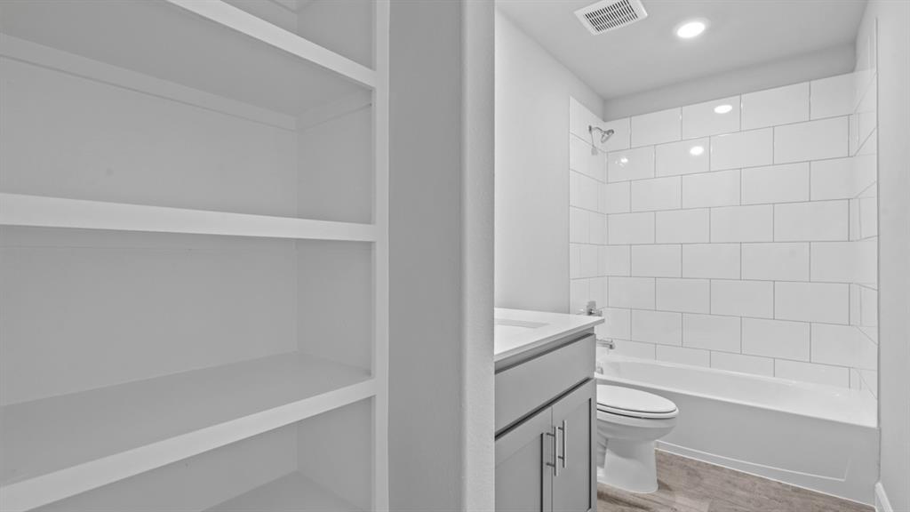 1909 Cookes Lane Cleburne, TX 76033 - Photo 31 of 40 a bathroom with a toilet and a bathtub