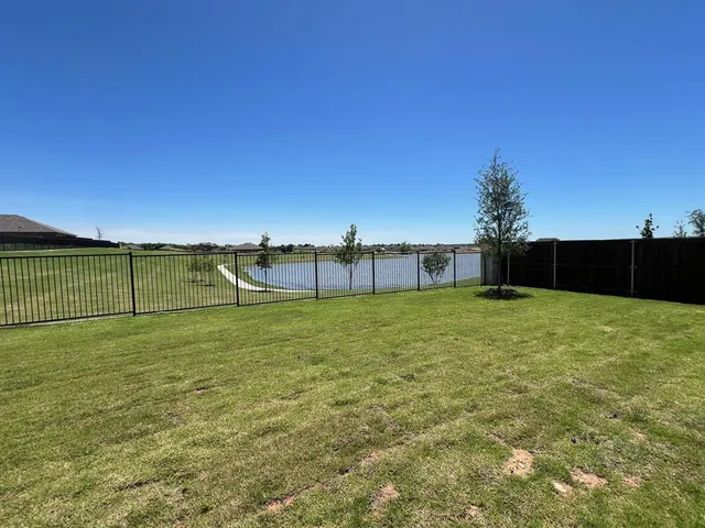 a view of a house with a yard and sitting area