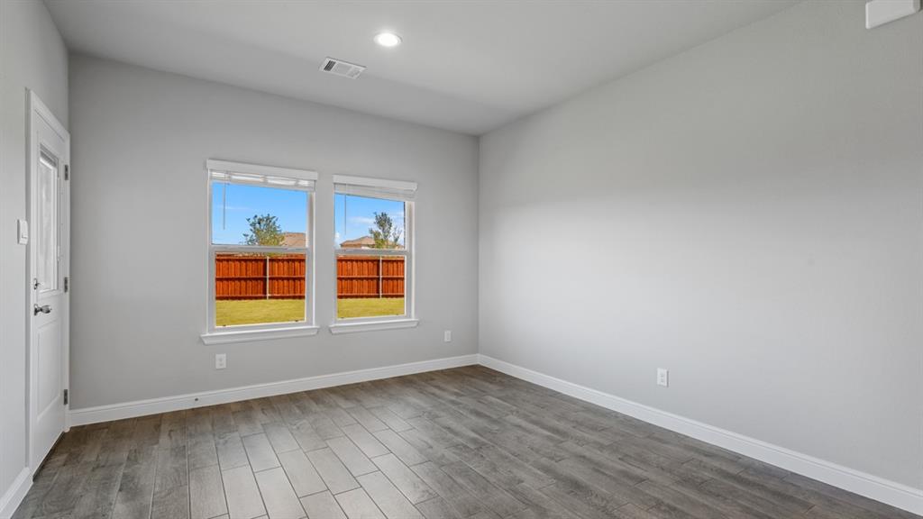 1909 Cookes Lane Cleburne, TX 76033 - Photo 5 of 40 an empty room with wooden floor and windows