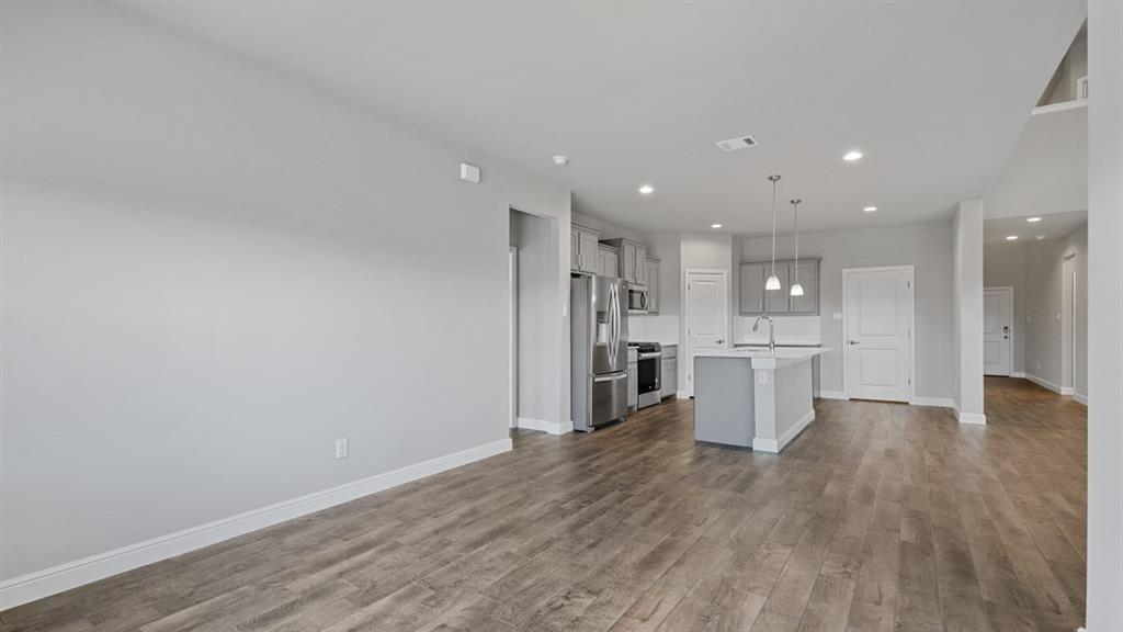 1909 Cookes Lane Cleburne, TX 76033 - Photo 6 of 40 a view of a kitchen with a sink and wooden floor