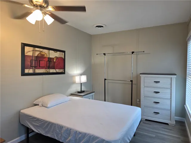 a bedroom with a bed and a dresser