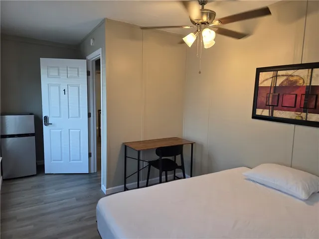 a bed room with a bed and a chandelier