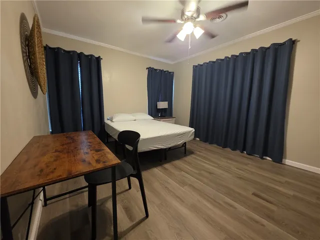 a bedroom with a bed closet and a chandelier